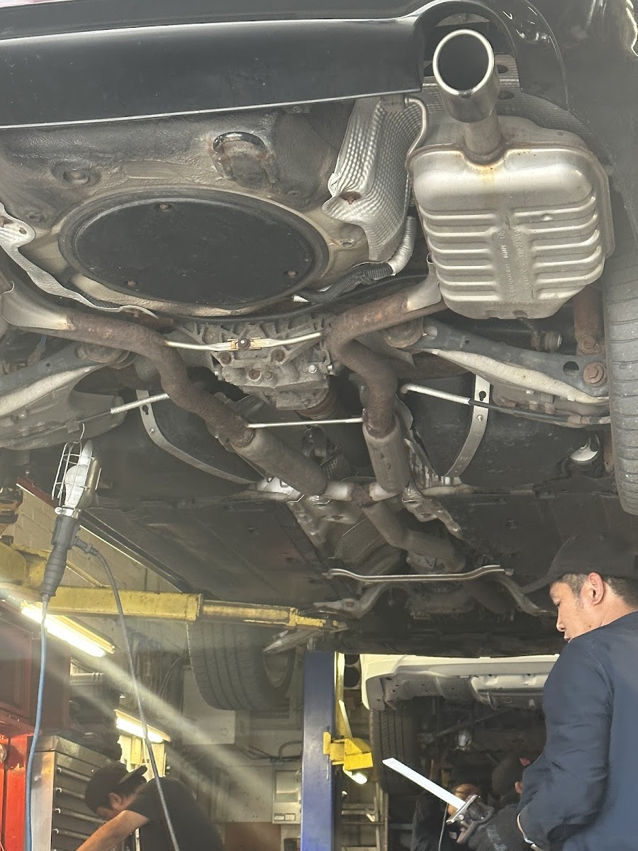 Underside of a car on the lift at Felix Muffler — exhaust system in view